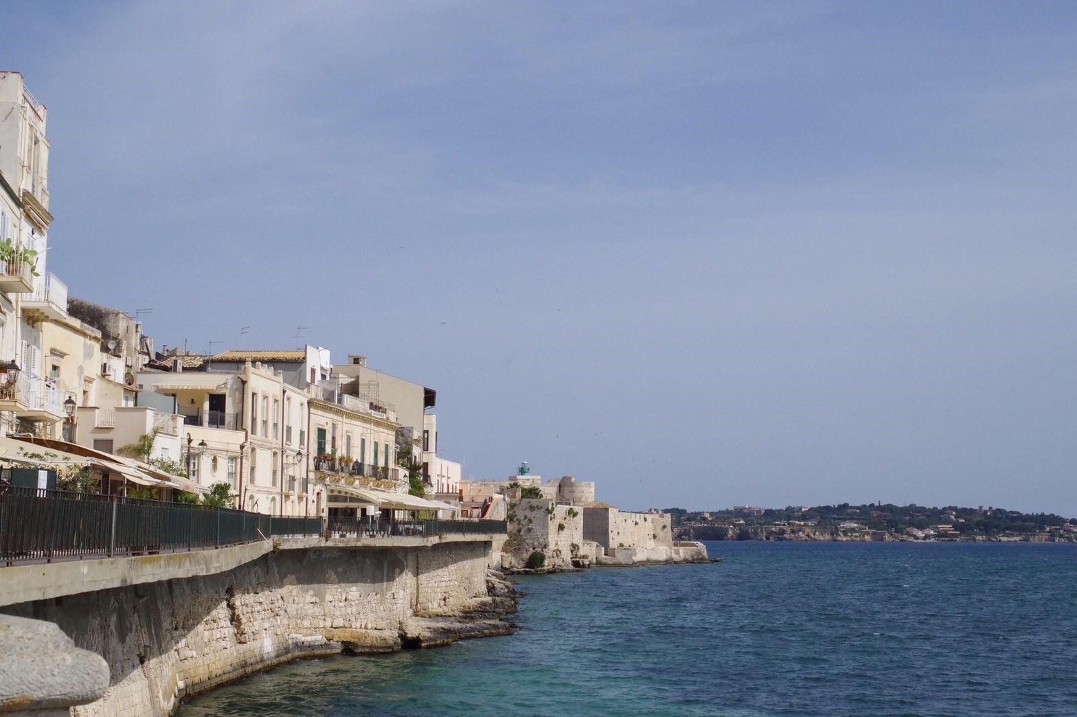 Stone houses along the waterfront and the calm Mediterranean
